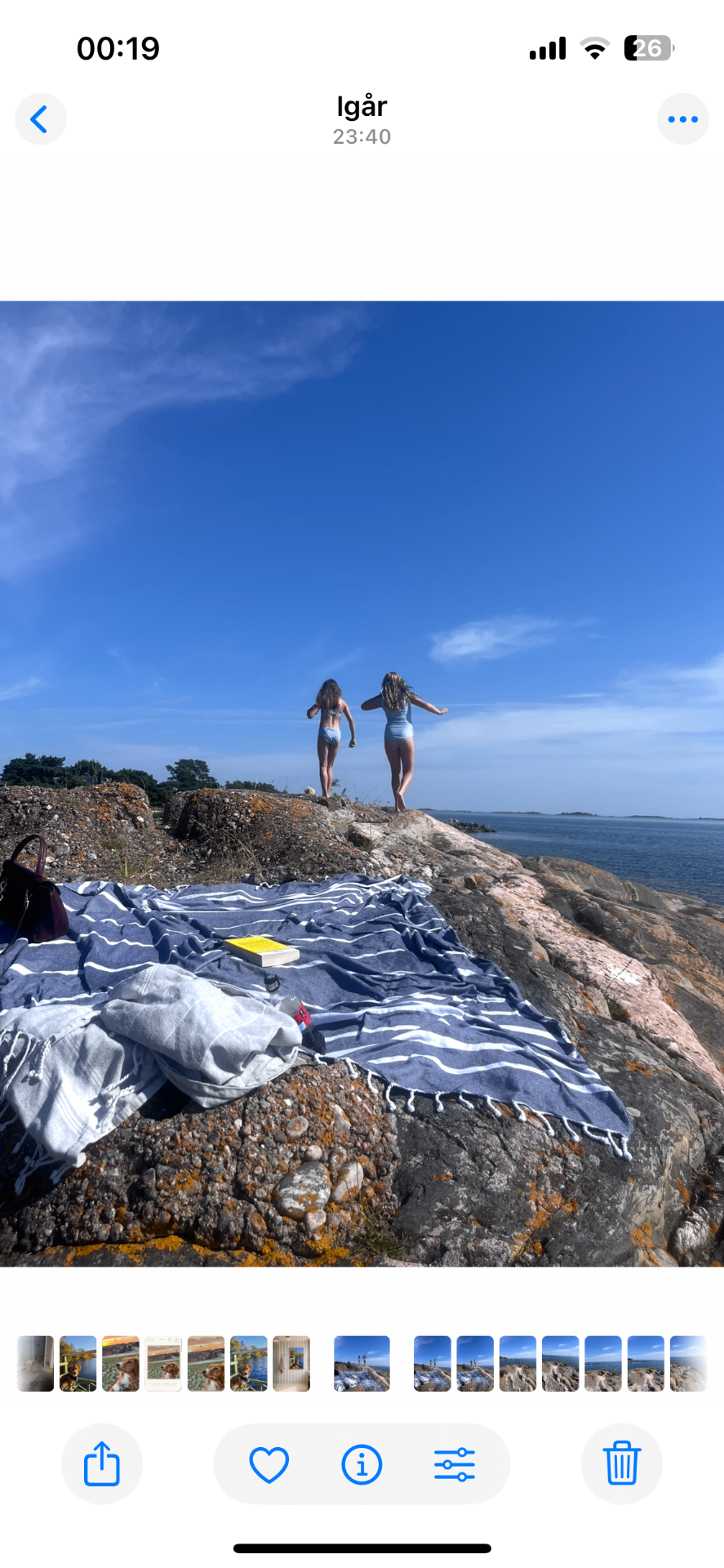 iPhone Photos app showing the original photograph of two girls on the archipelago rocks